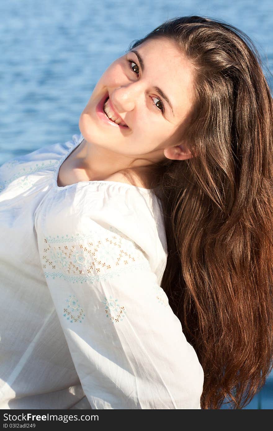 A Beautiful woman at the beach. Portrait of an attractive young woman. The concept of this picture is: holiday, fun, summer, happiness and lifestyle. A Beautiful woman at the beach. Portrait of an attractive young woman. The concept of this picture is: holiday, fun, summer, happiness and lifestyle.