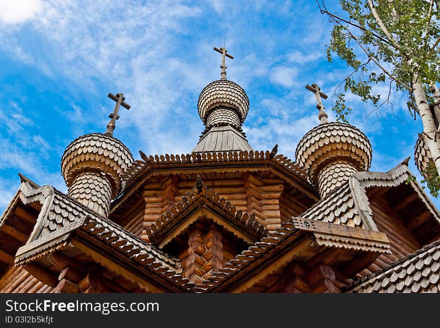 A wooden church was built in the old Russian style at the blue sky