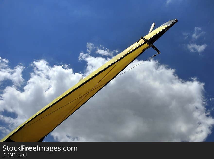 Skiff bows against a sunny blue sky, like a rocket