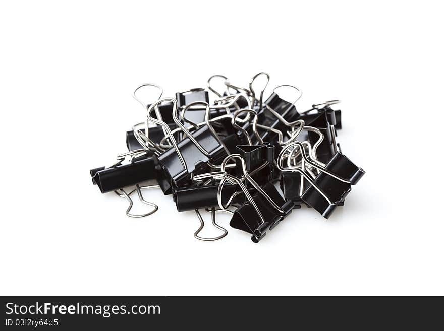 A black binder clip against a white background