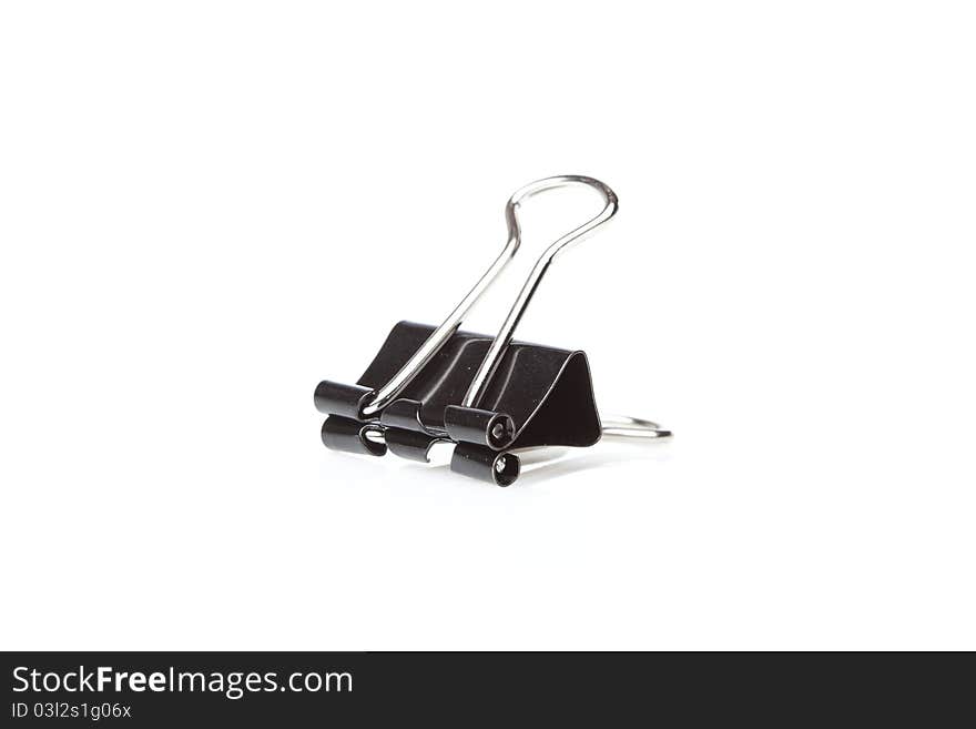 A black binder clip against a white background