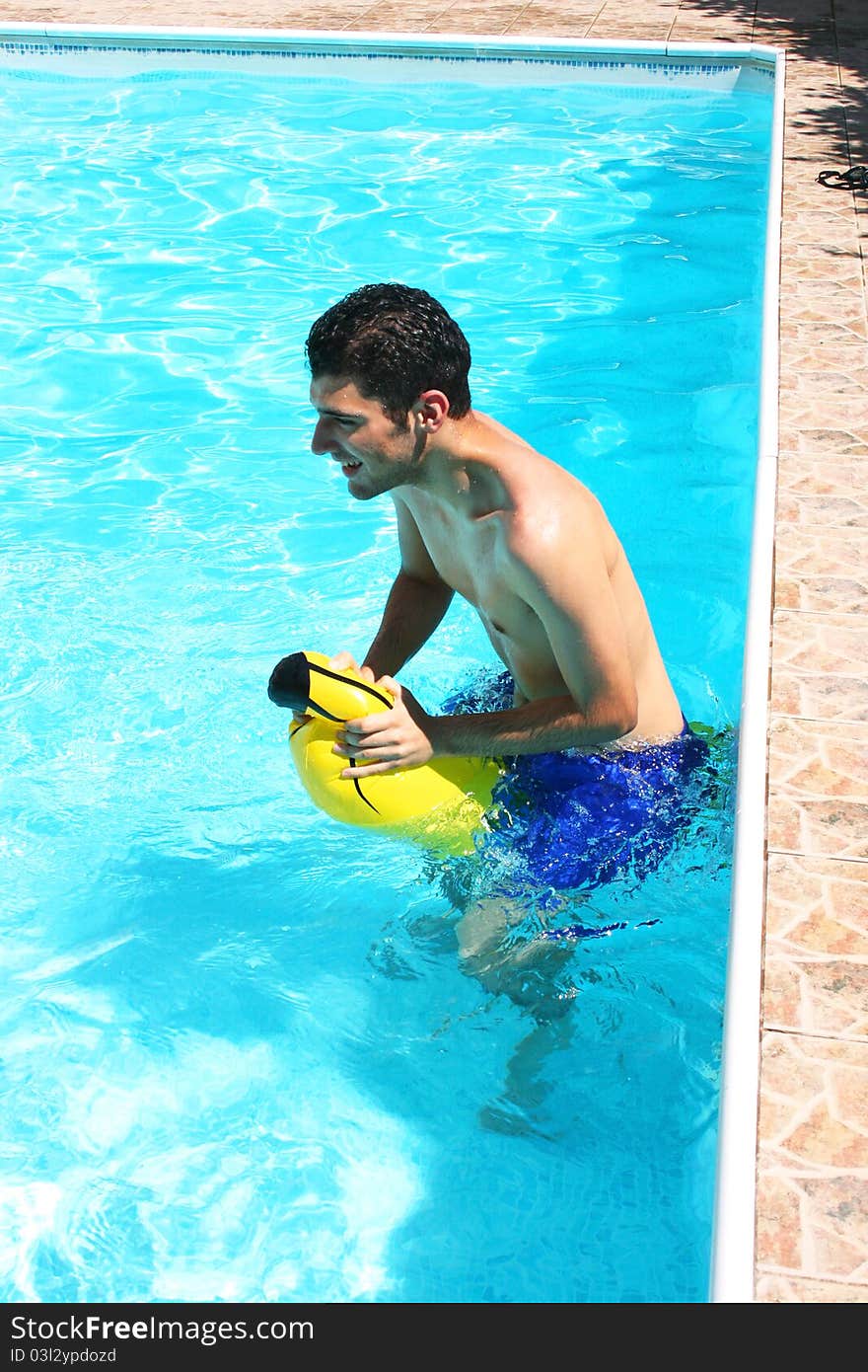 Man with yellow banana in swimming pool. Man with yellow banana in swimming pool.