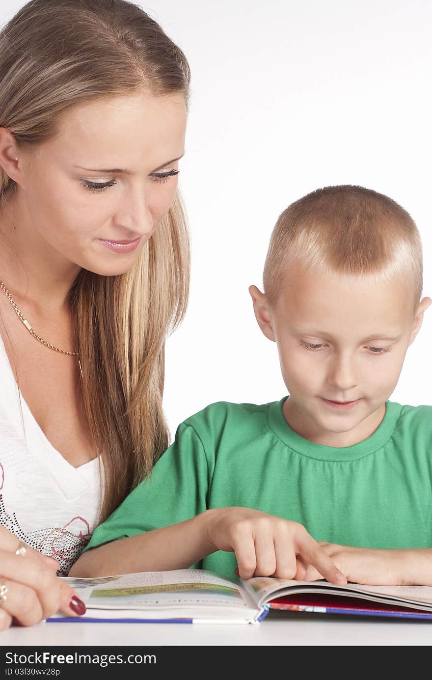 Happy mom and her son reading on white. Happy mom and her son reading on white