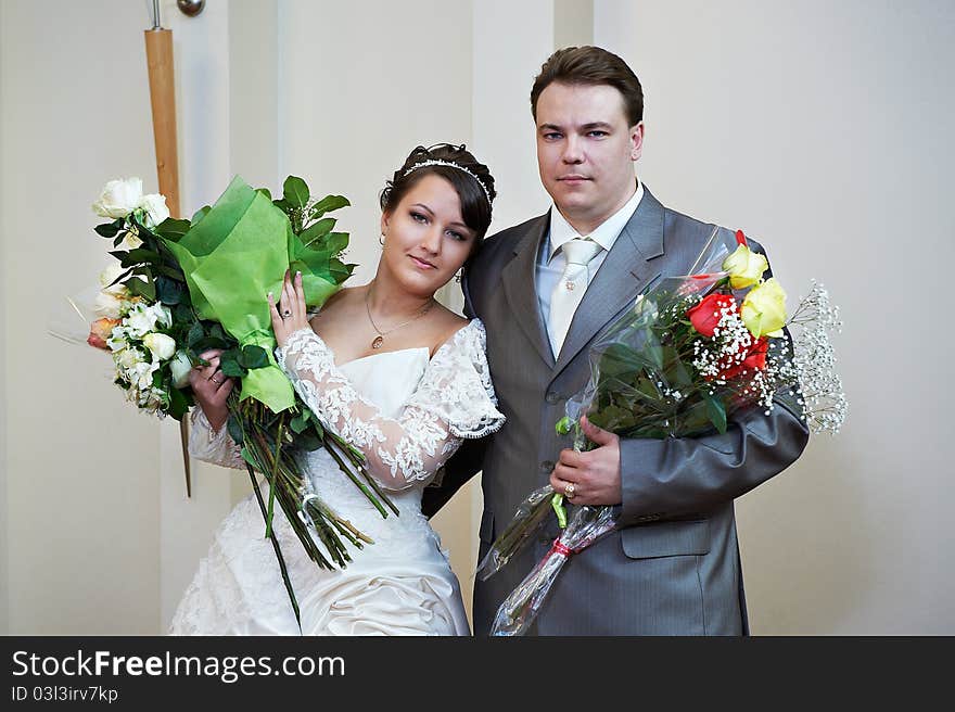 Bride and groom with flowers after solemn registration