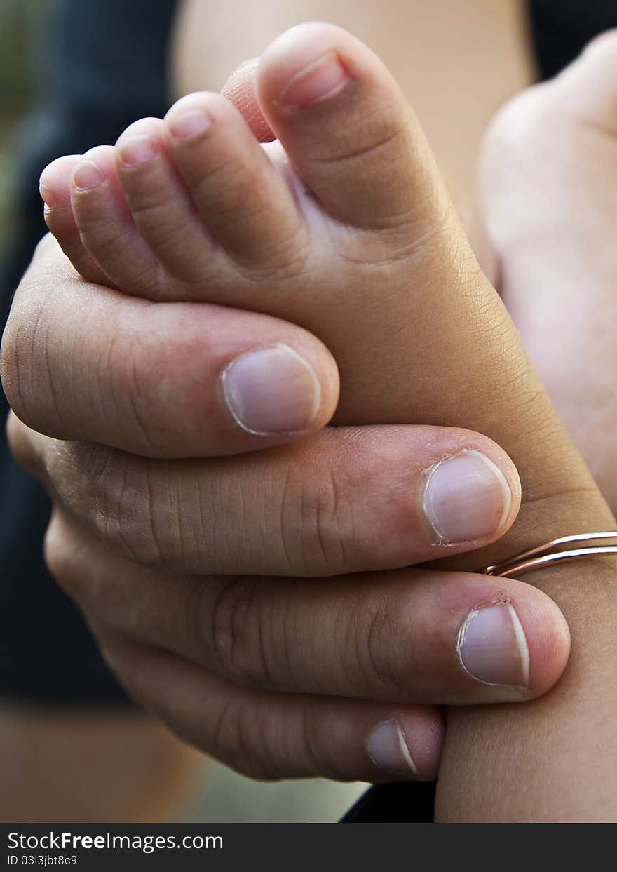 Baby's foot in hand of his father. Baby's foot in hand of his father