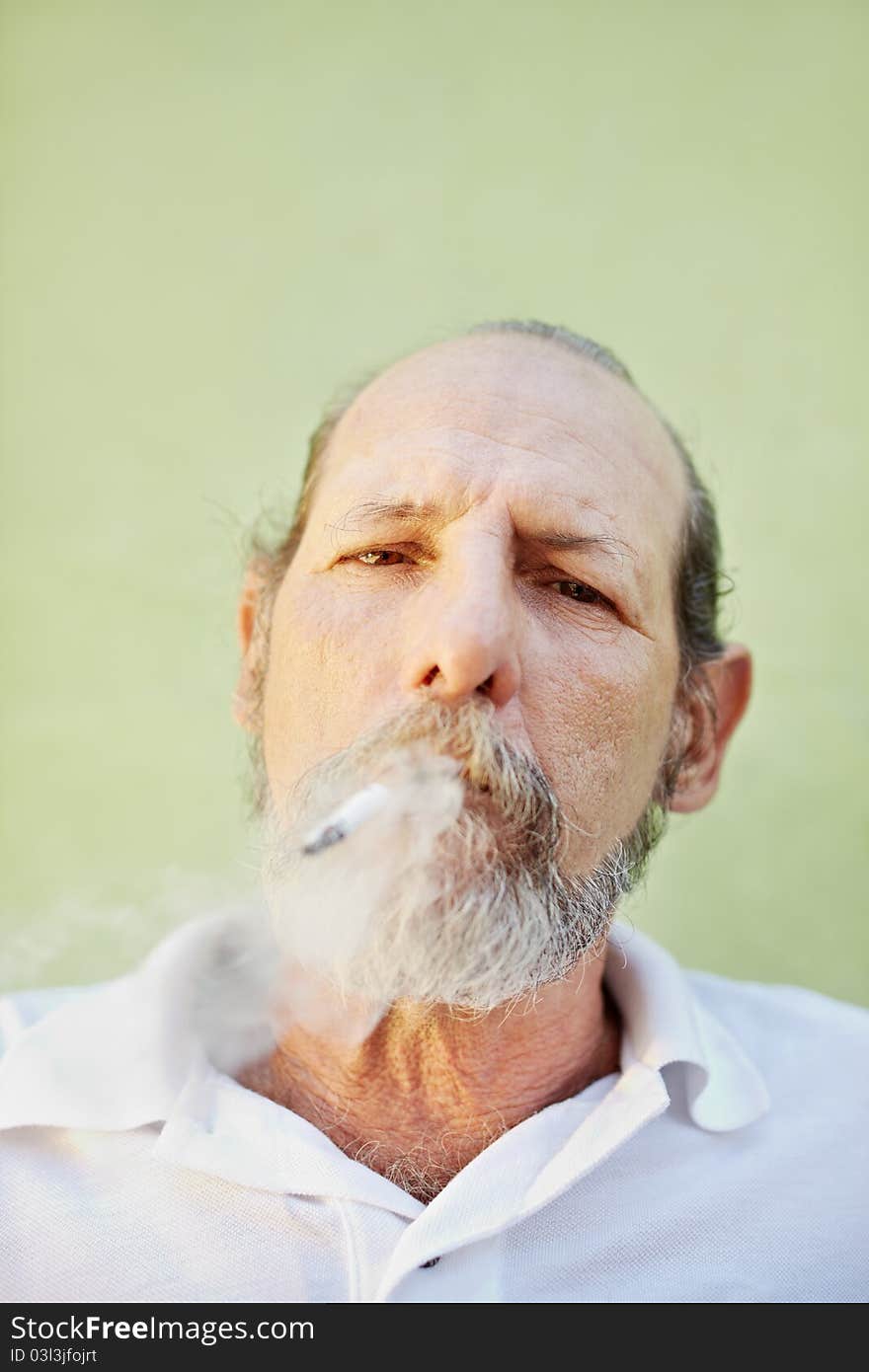 Aged Caucasian Man Smoking Cigarette