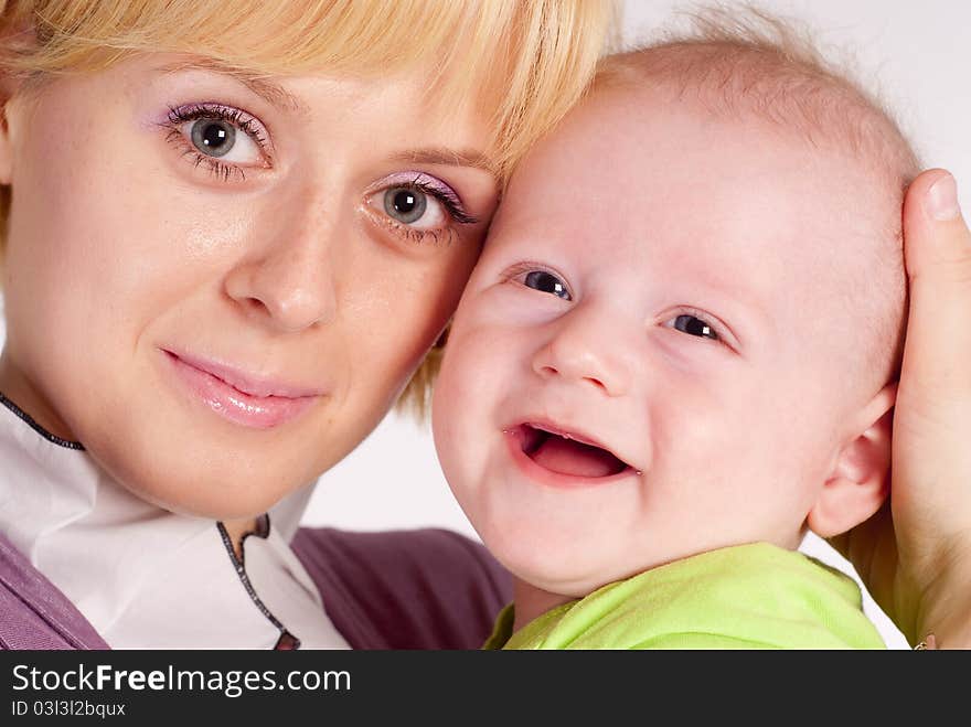 Happy mom holds her baby on white. Happy mom holds her baby on white