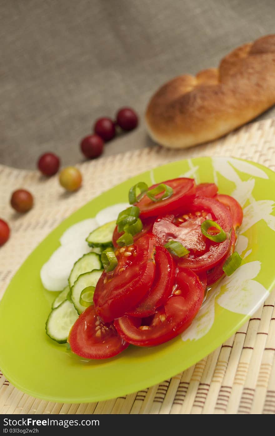 A vegetable salad on a  green plate