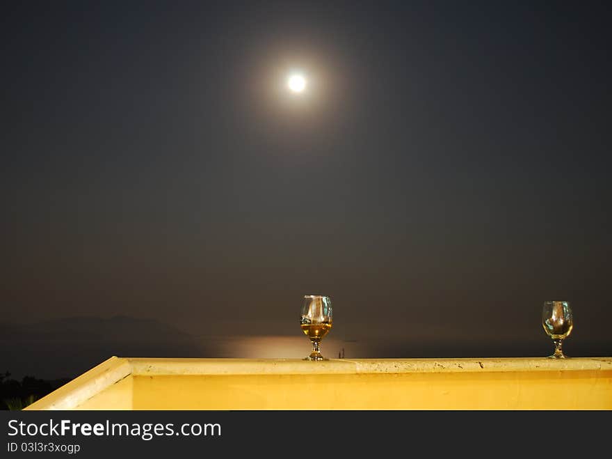 Romantic Scene of Wineglass and Full Moon with Sea at Background