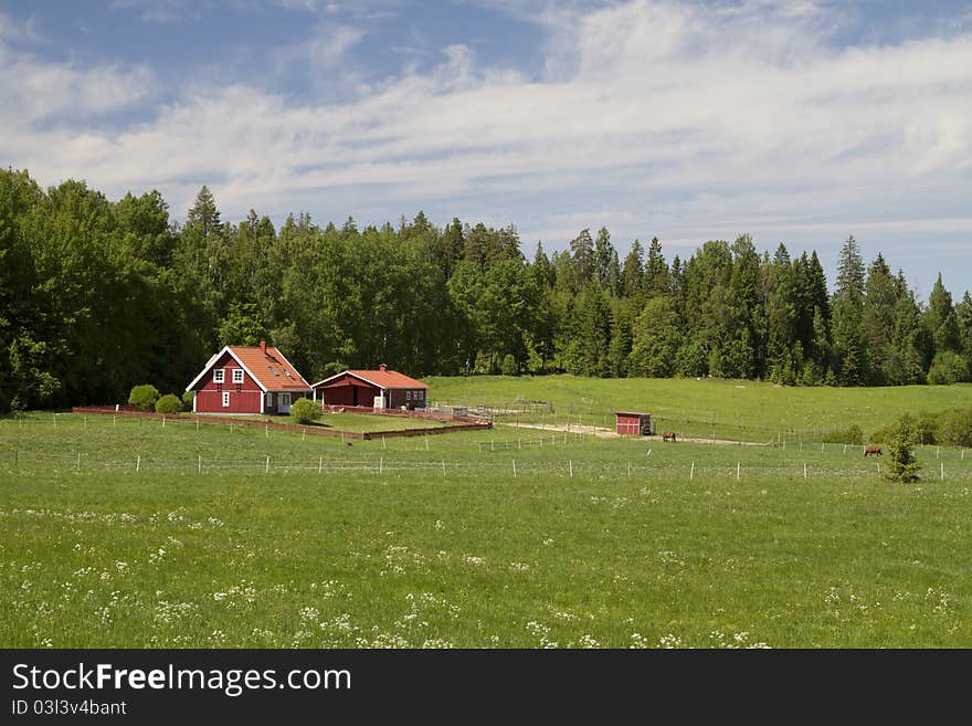 Traditional Scandinavian country house and corral for horses. Traditional Scandinavian country house and corral for horses