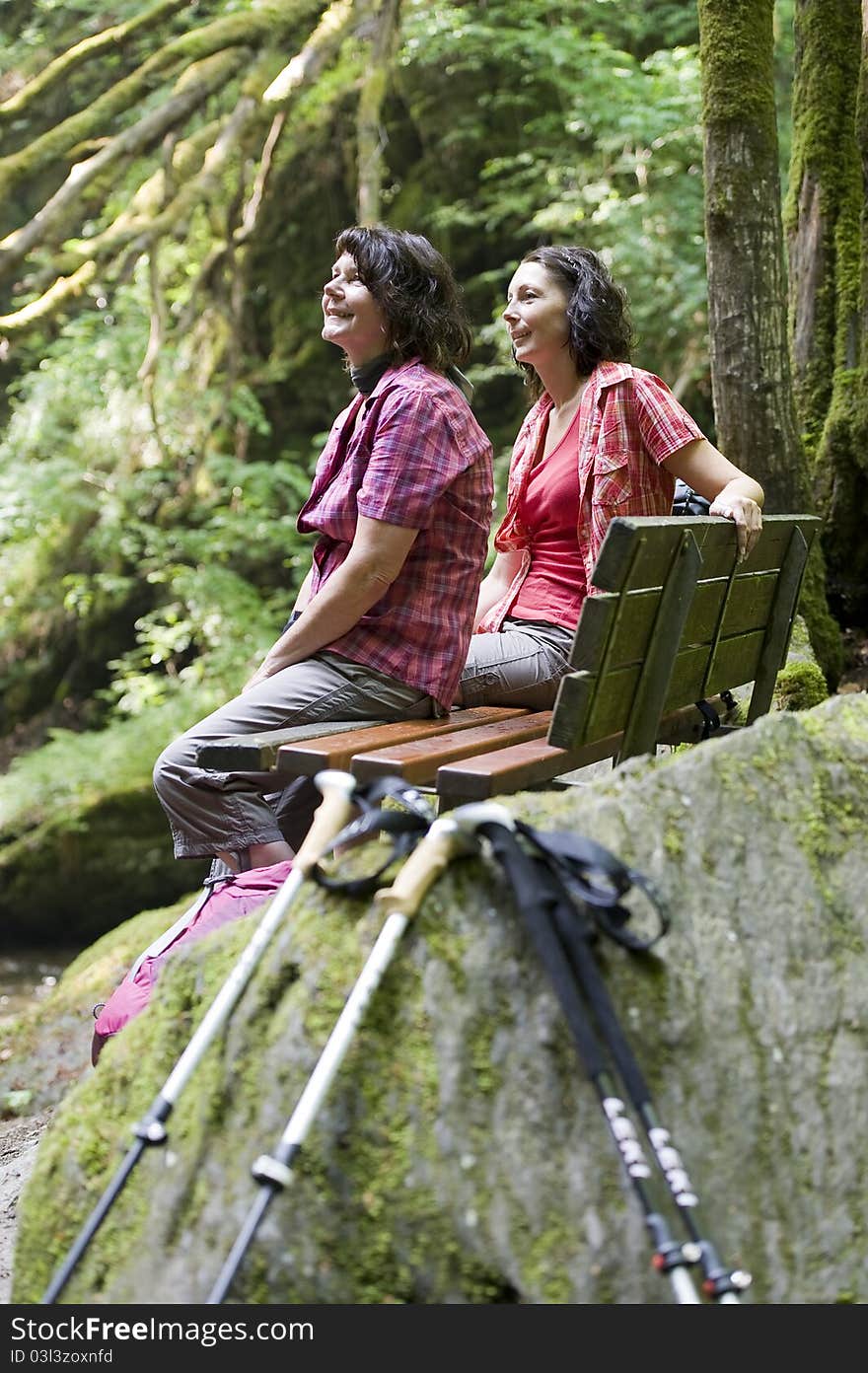 Mother and daughter doing a break while hiking