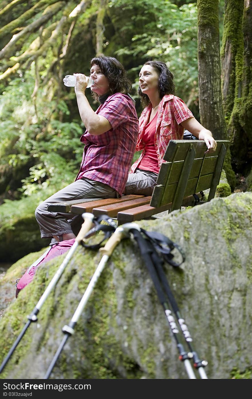 Mother and daughter doing a break while hiking