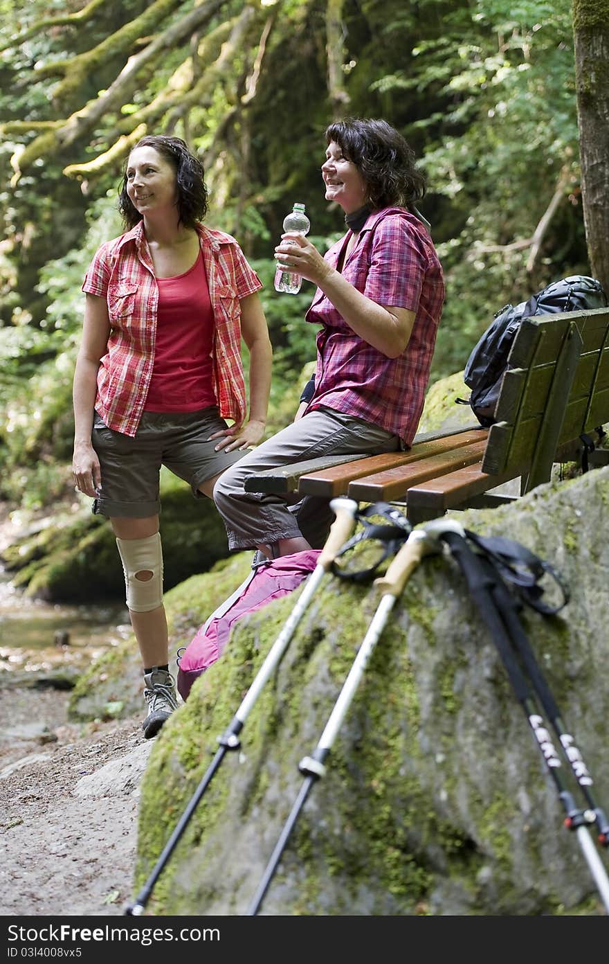 Mother and daughter doing a break while hiking