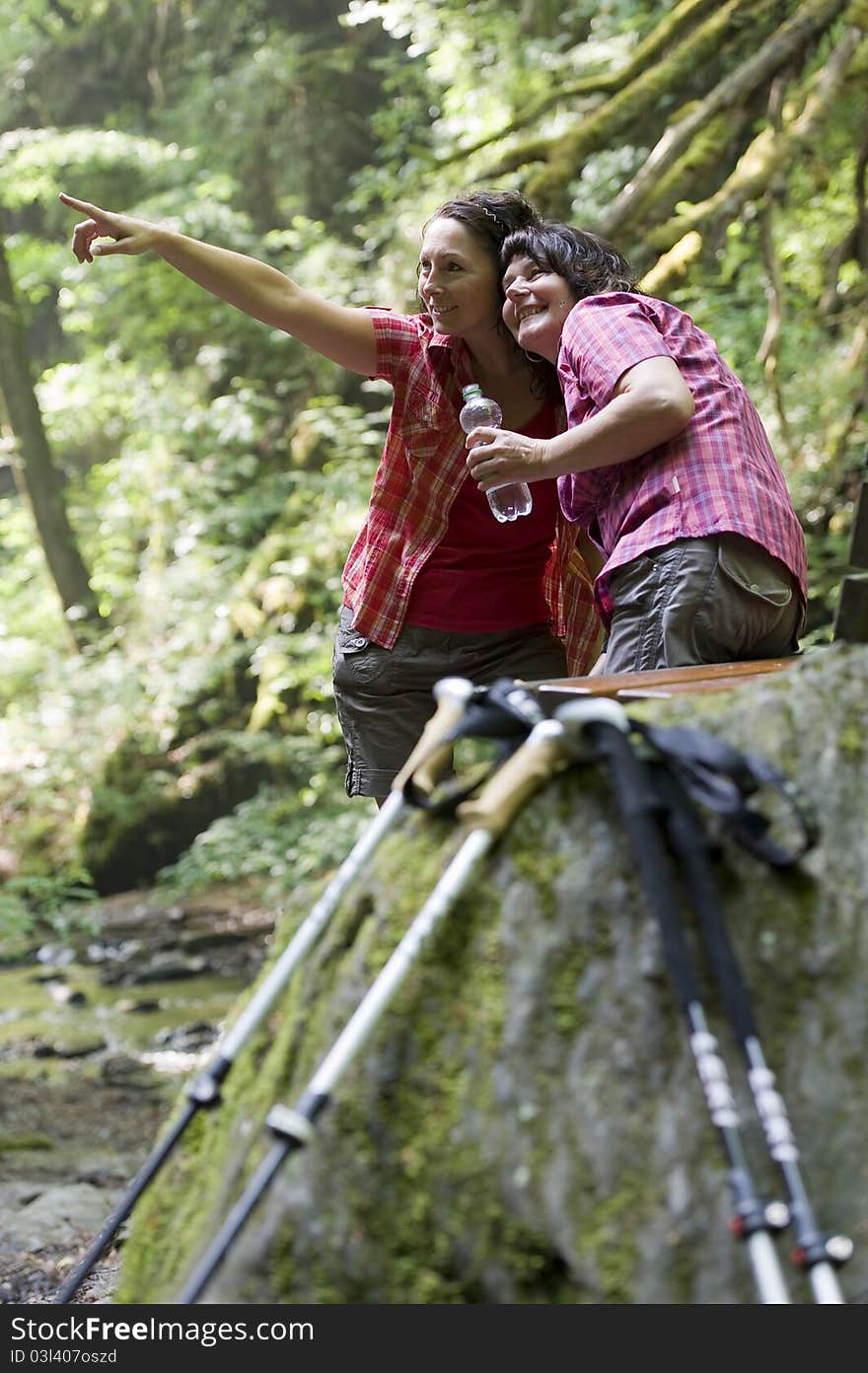 Mother and daughter doing a break while hiking