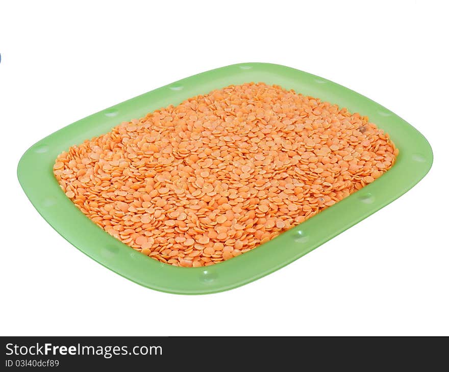 Lentils on a plate on a white background