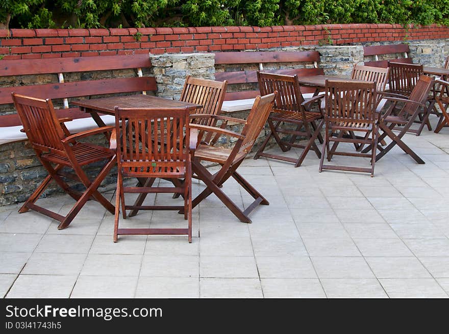 Wooden Chairs And Tables In The  Resort.