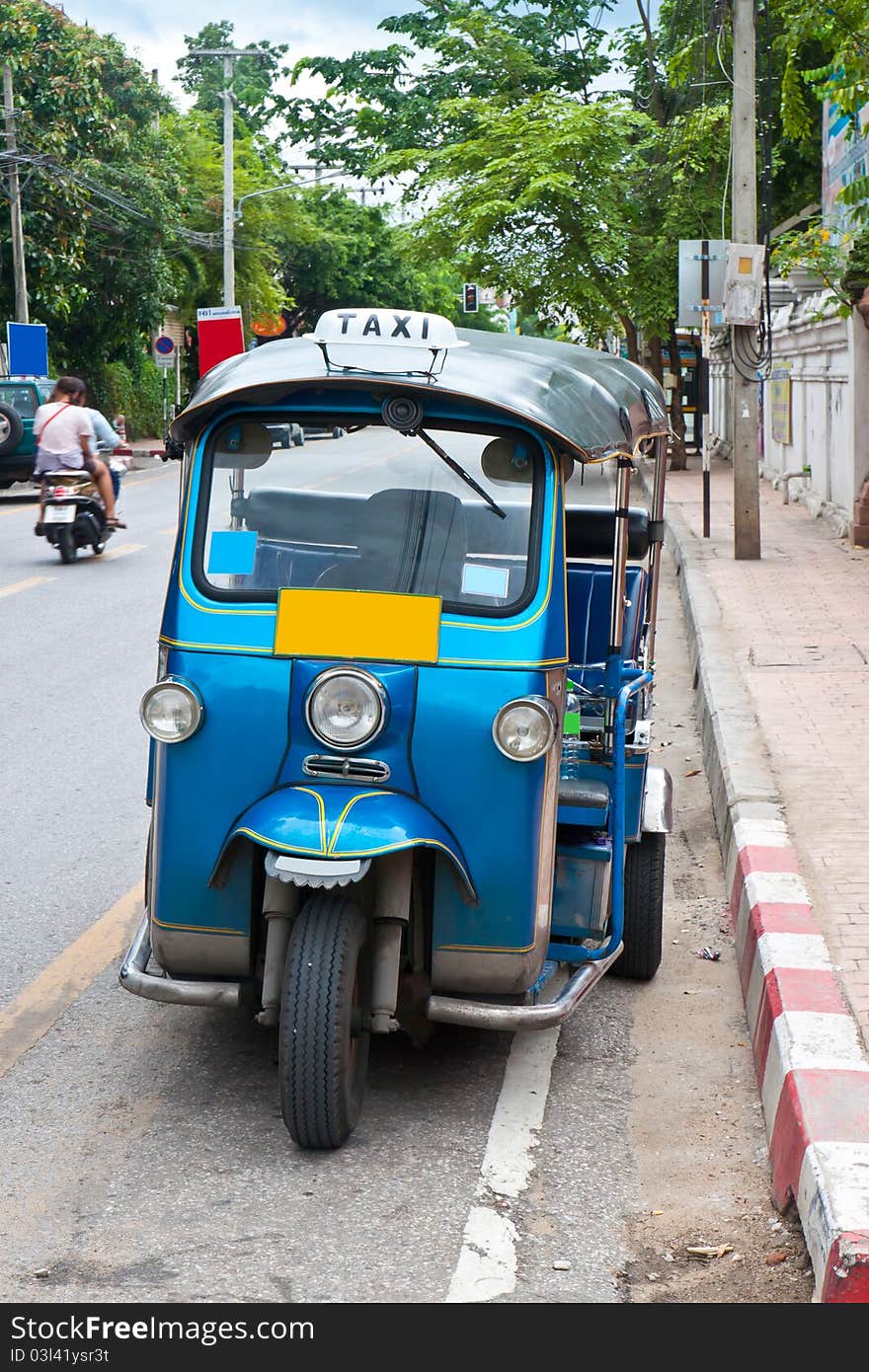 Thai tuk tuks sit parked awaiting tourists