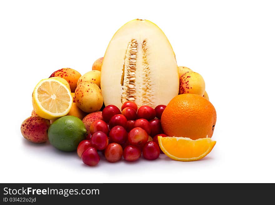 Fruit selection with melon, apricots, cherry, lemon, lime and orange isolated on white background. Fruit selection with melon, apricots, cherry, lemon, lime and orange isolated on white background