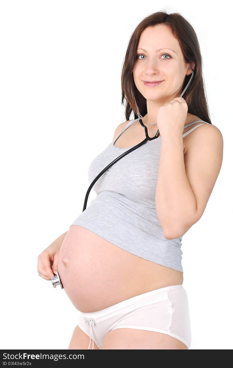 Young pregnant woman listening stethoscope of his future child. Young pregnant woman listening stethoscope of his future child