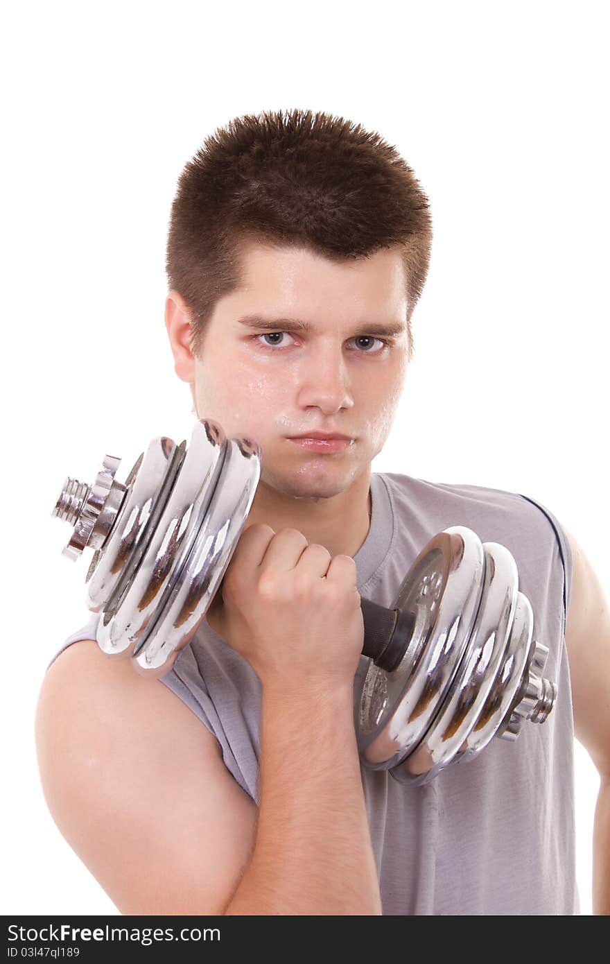 Young man exercising with a dumbbell. Young man exercising with a dumbbell