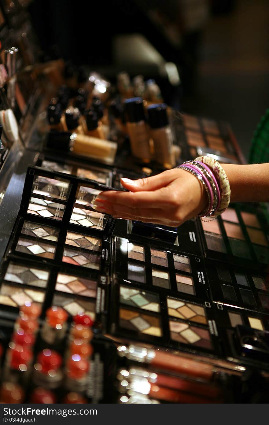 Display of make up with female hand. Display of make up with female hand