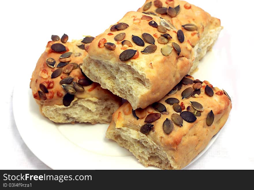 Small bread with pumpkin seeds close up isolated