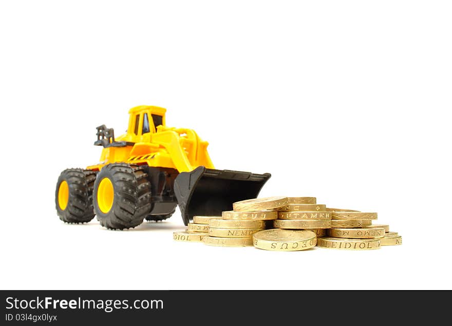 Toy construction truck next to a heap of coins. Toy construction truck next to a heap of coins