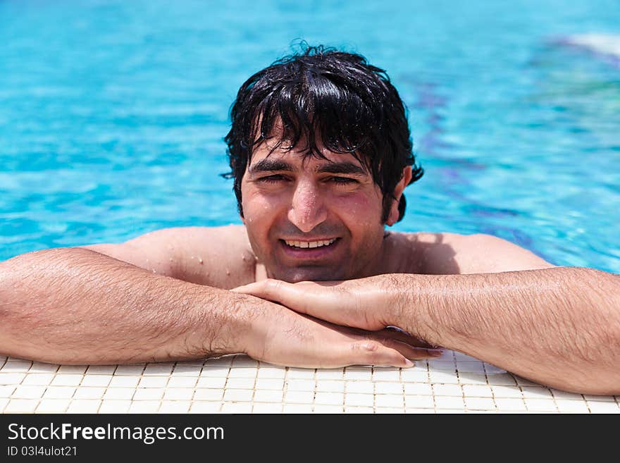 Man smiling and relaxing in swimming-pool. Man smiling and relaxing in swimming-pool