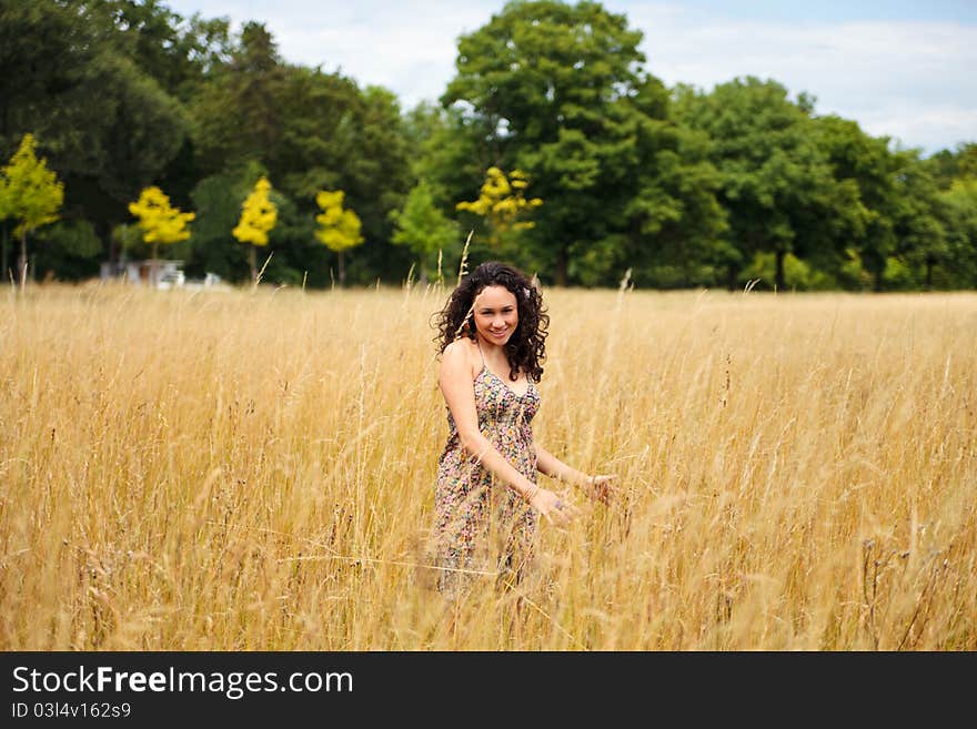 Beautiful, playful woman, hispanic, Latina standing in the field. Beautiful, playful woman, hispanic, Latina standing in the field