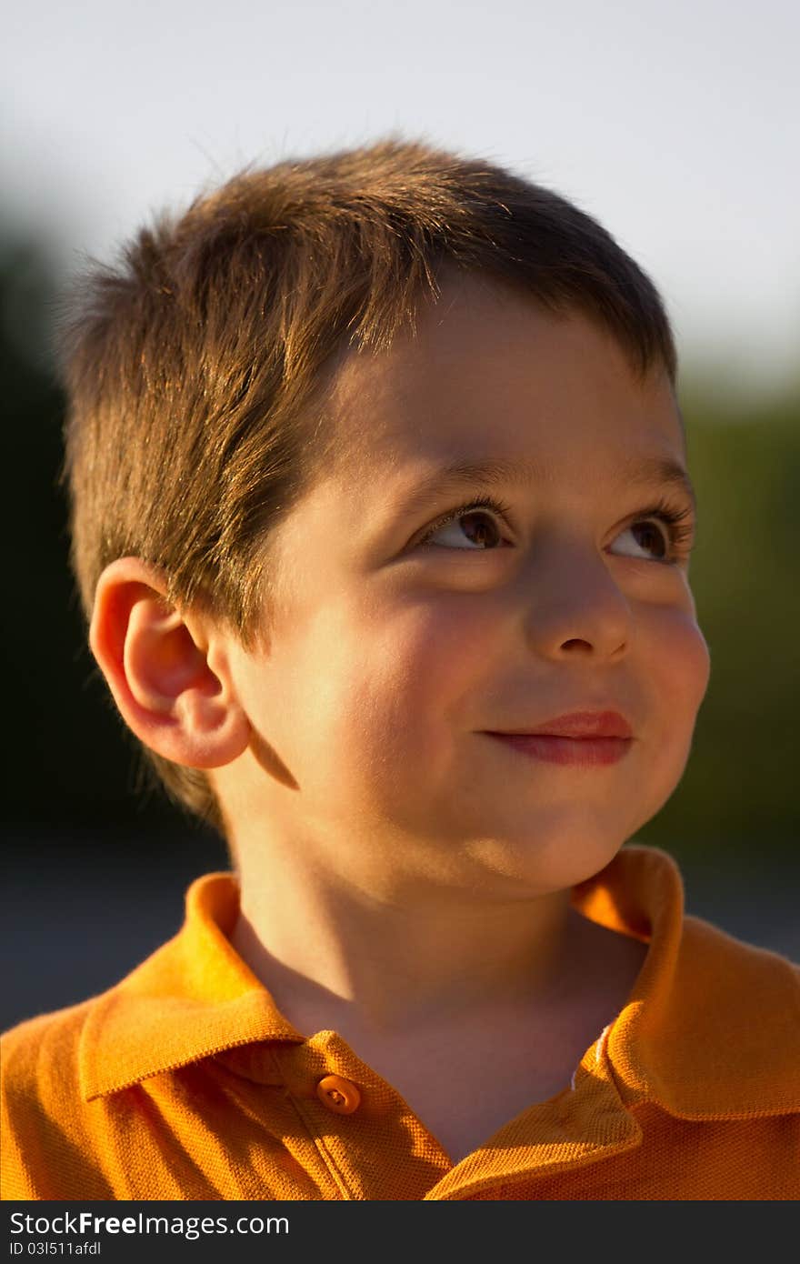 A cute boy looking up and smiling