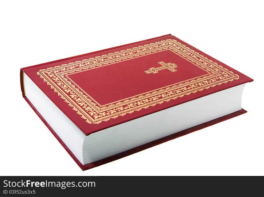 The red orthodox bible with a cross and on a white background (focus on a cross). The red orthodox bible with a cross and on a white background (focus on a cross)