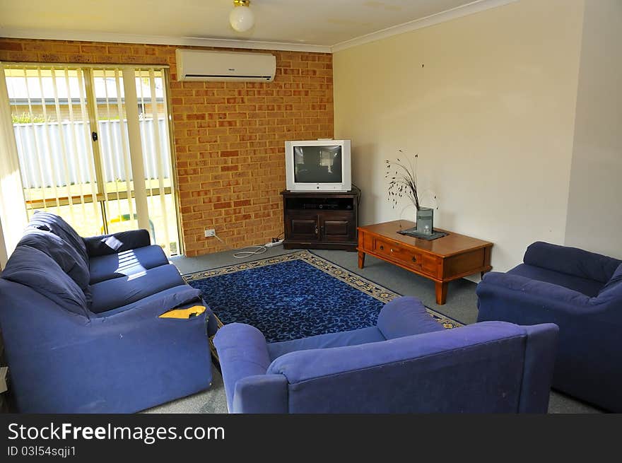 Interior of simple commong room with sofa and television. Interior of simple commong room with sofa and television.