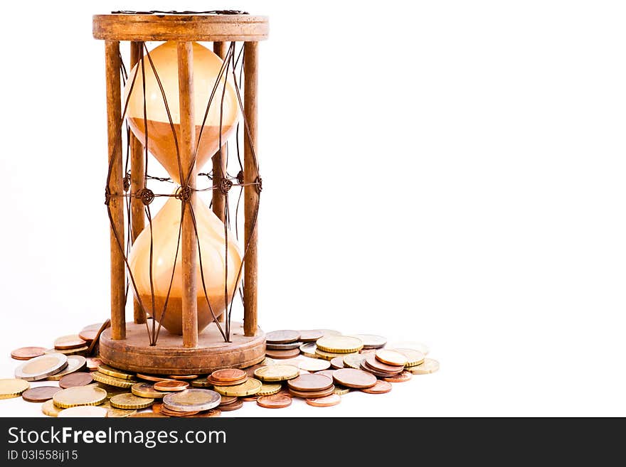 Old hourglass (made in India, XIX century) with euros. Old hourglass (made in India, XIX century) with euros