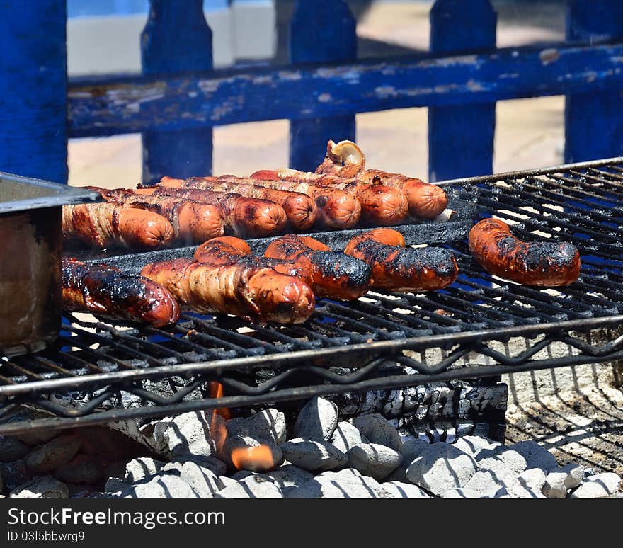 Summertime Barbecue with sausages on the grill. Summertime Barbecue with sausages on the grill.