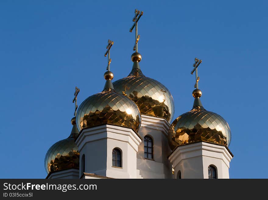 Four golden domes of the Orthodox Church against the blue sky. Four golden domes of the Orthodox Church against the blue sky