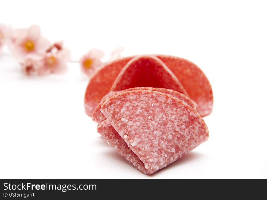 Salami folded onto white background