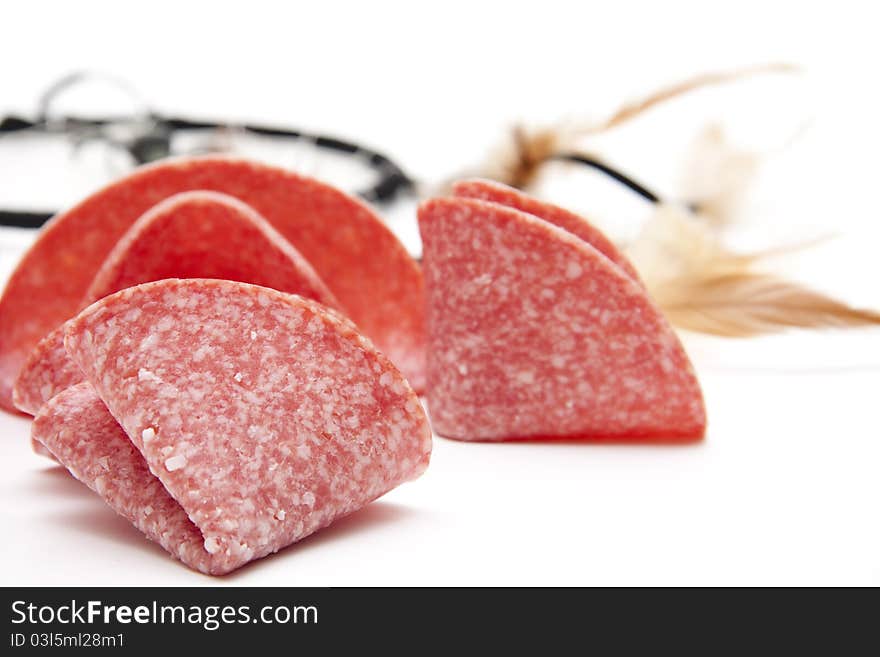 Salami folded onto white background