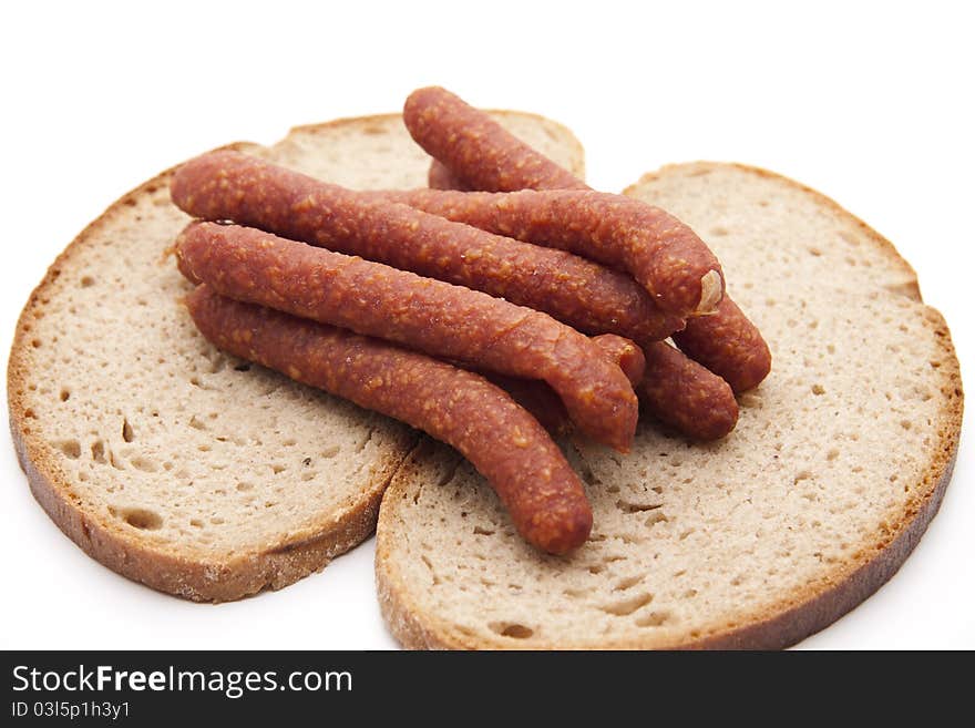 Mead sausage with bread onto white background