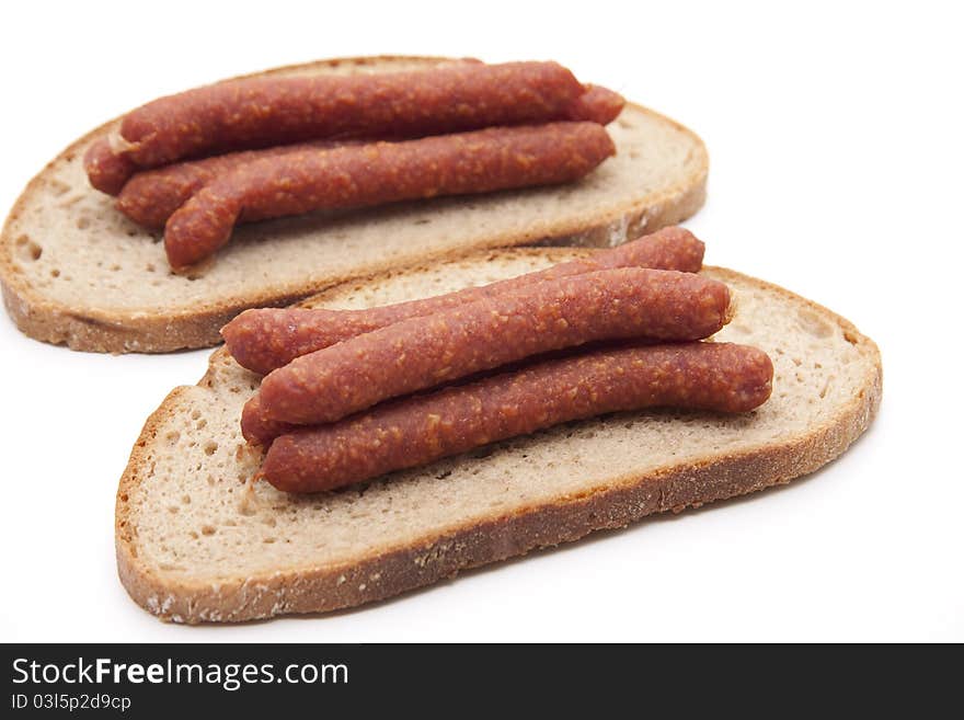 Mead sausage with bread onto white background