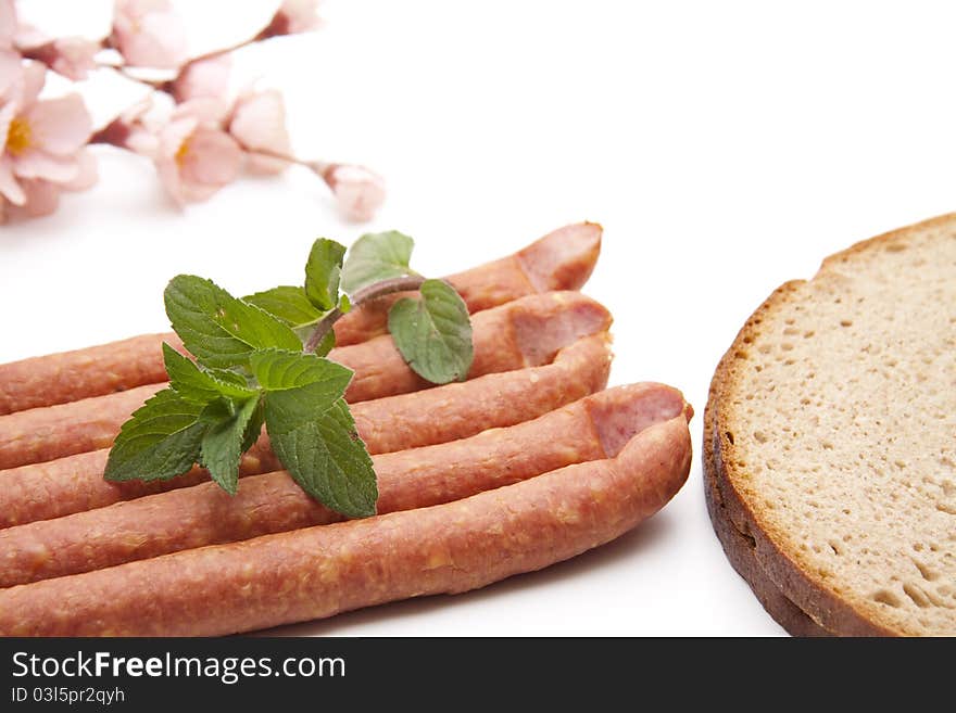 Mead sausage with bread and mint onto white background. Mead sausage with bread and mint onto white background