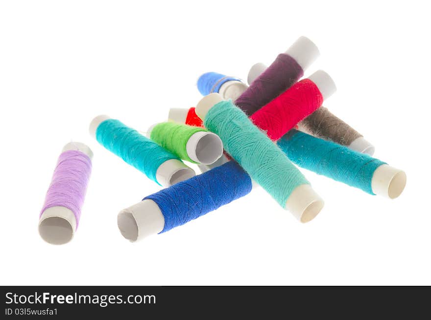 Multicolored spools of thread isolated on a white background