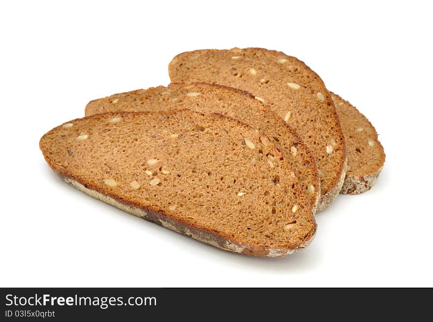 Sliced brown bread with sunflower seeds isolated on a white background