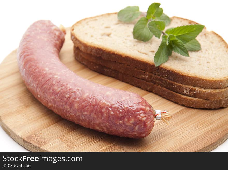 Garlic salami and bread onto white background