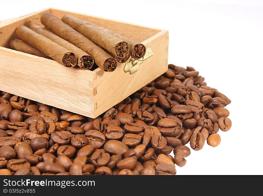 Many coffee beans and cigarettes of a white background