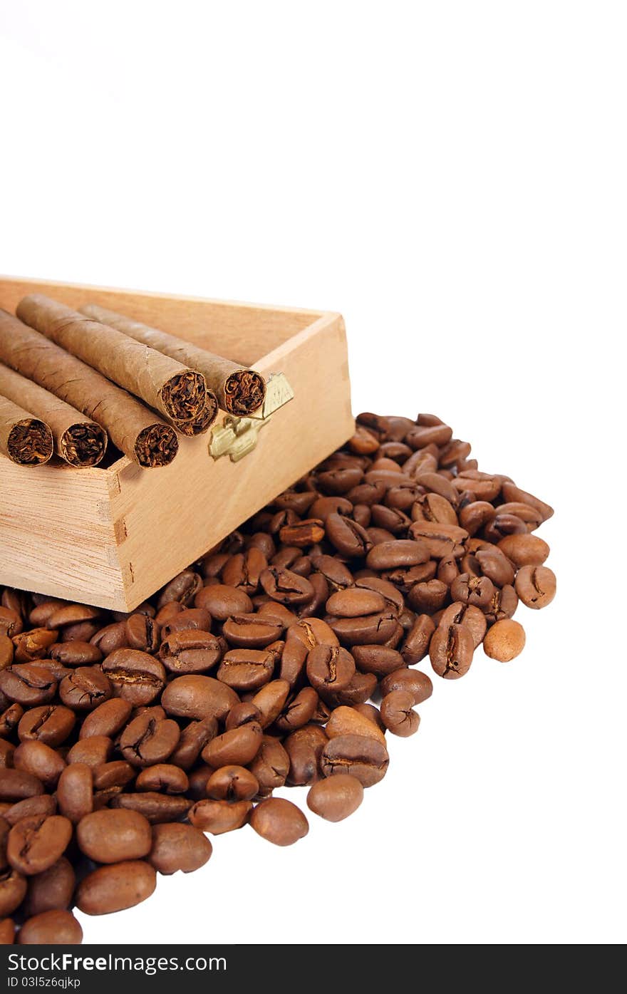 Many coffee beans and cigarettes of a white background