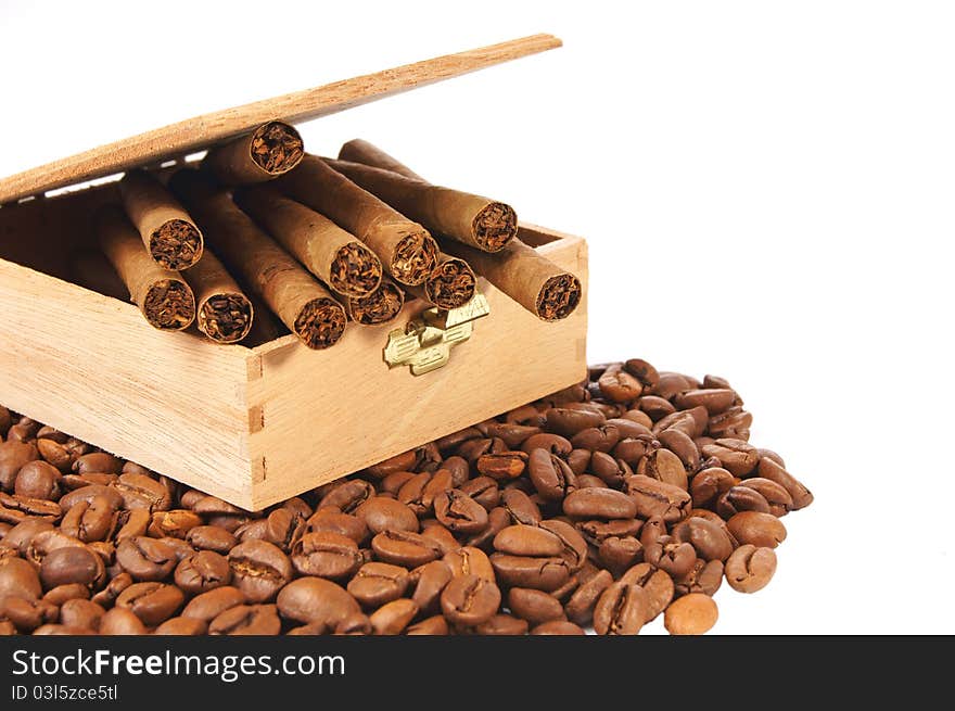 Many coffee beans and cigarettes of a white background