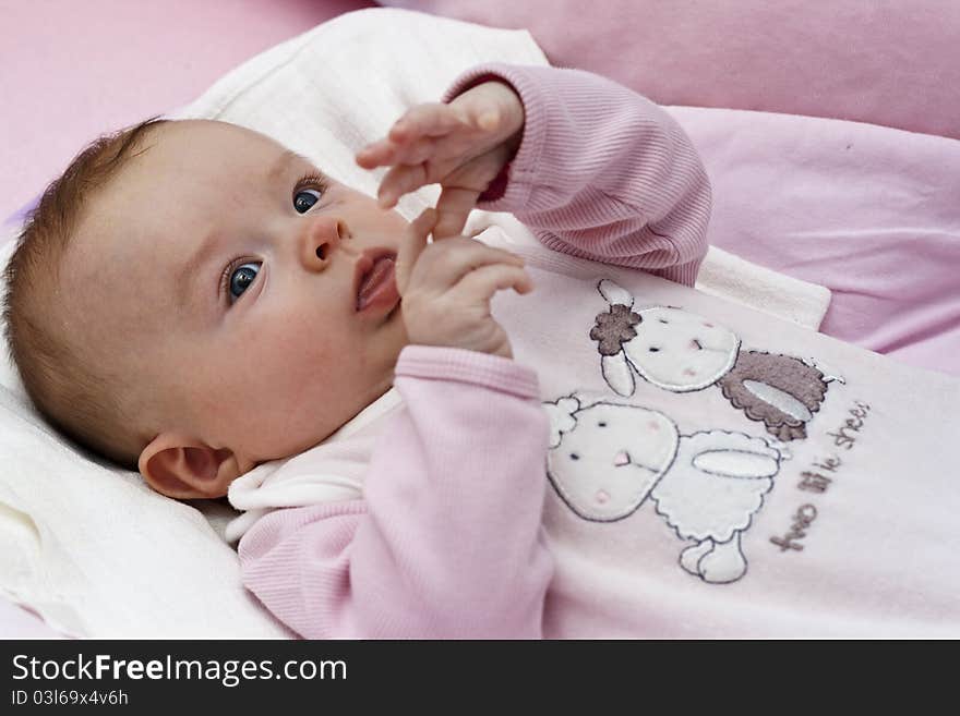 Small baby playing with hands and fingers, counting fingers