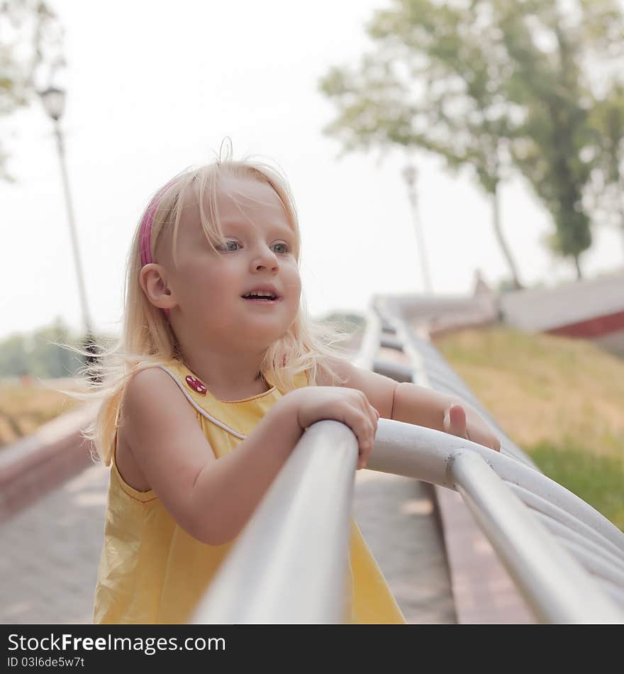 Little happy girl at the summer park