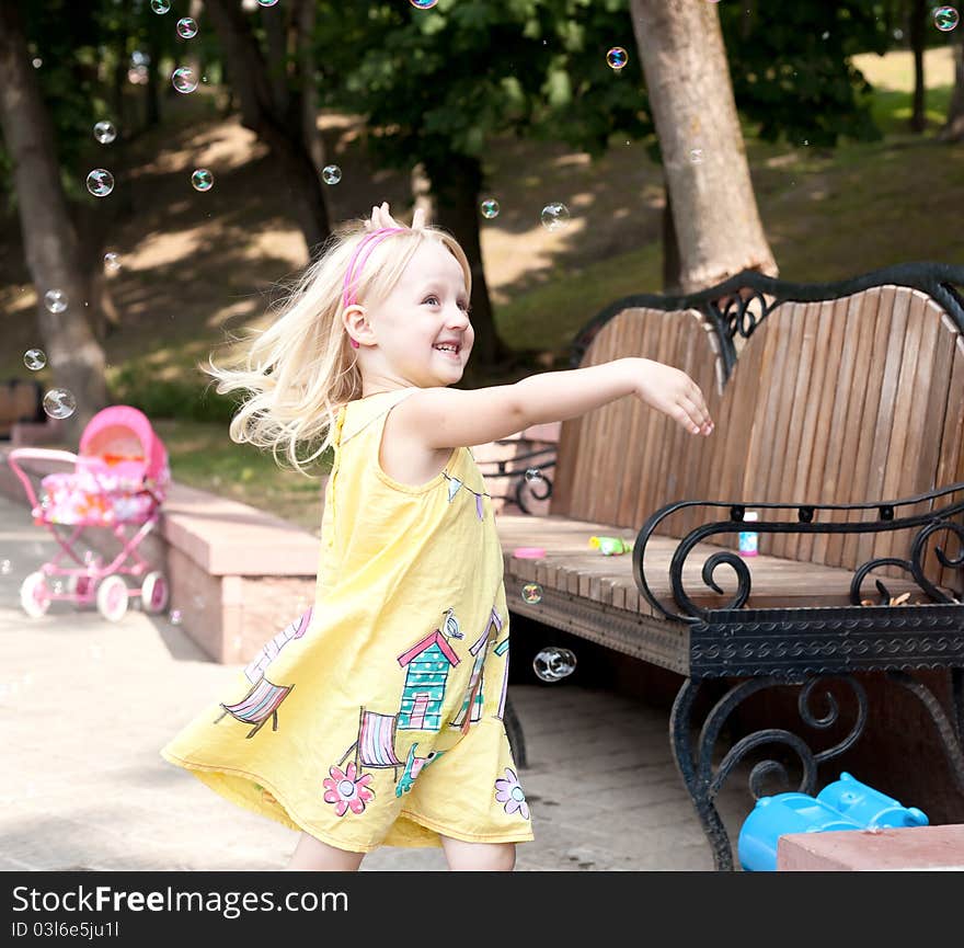 Running open arms little happy girl at the park