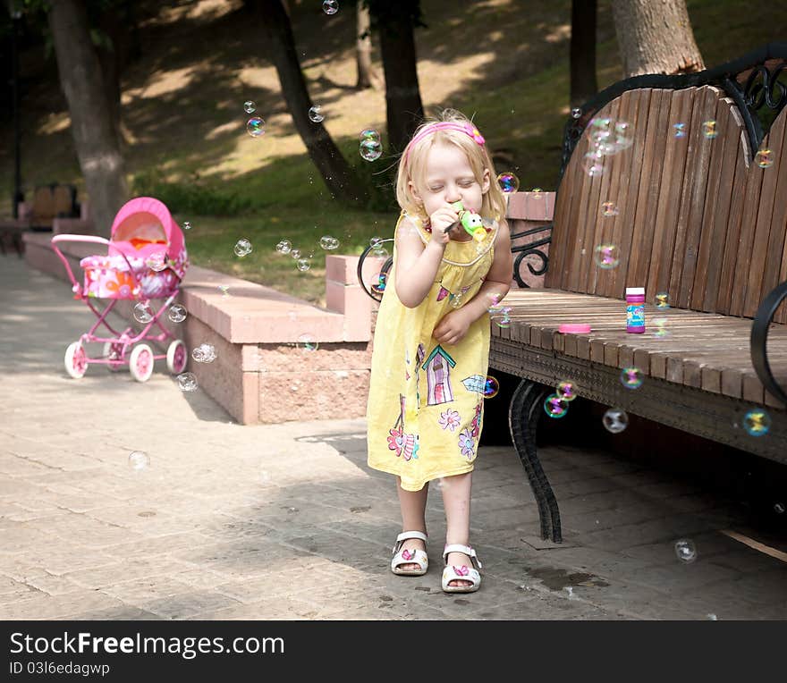 Little happy girl at the summer park